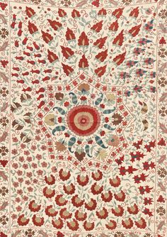 an intricately designed rug with red and blue accents