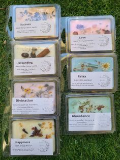 six soaps with different types of flowers in them sitting on the grass, all individually labeled