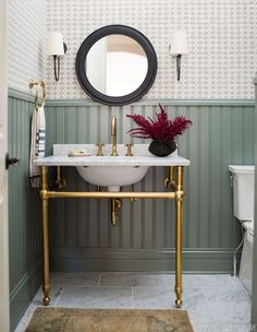 a white sink sitting under a mirror in a bathroom