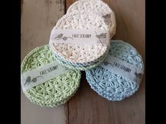 three crocheted coasters sitting on top of a wooden floor next to each other