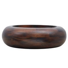 a wooden bowl sitting on top of a white surface