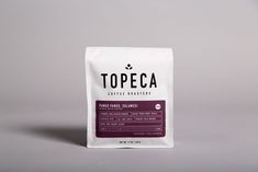 a bag of topeca coffee on a grey background