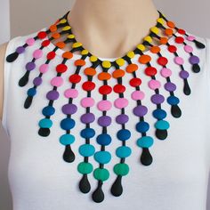 a woman wearing a multicolored necklace on her neck