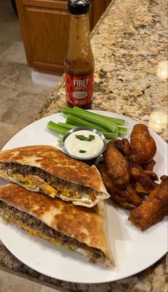 two quesadillas on a white plate with green beans and dipping sauce next to them