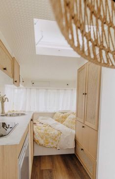 a small bedroom with white walls and wood flooring is seen in this image from the inside