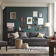 a living room filled with lots of furniture and pictures on the wall above it's couch