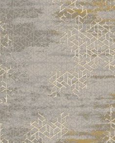 a gray and gold rug with an abstract design on the bottom, in shades of grey