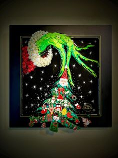 a christmas tree made out of candy and candies in front of a black background