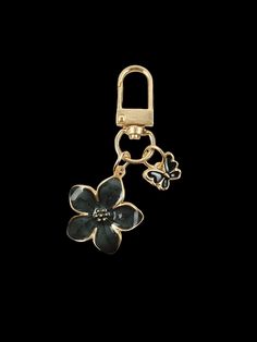 a gold key chain with a flower on the bottom and a lock attached to it