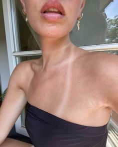 a woman in a strapless dress posing for the camera