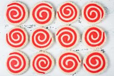 several red and white cookies are arranged in the shape of a spiral