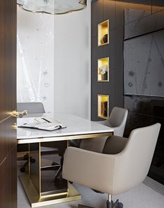 an office with a desk, chair and laptop on the table in front of it