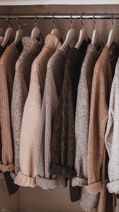 a row of sweaters hanging on a rack