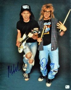 two young men are posing with their guitars