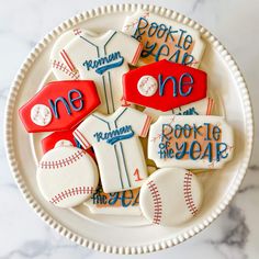 decorated cookies in the shape of baseballs on a plate