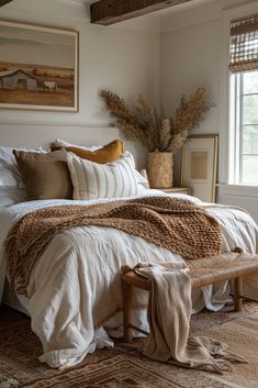 a bed with white sheets and pillows in a bedroom next to a window filled with plants