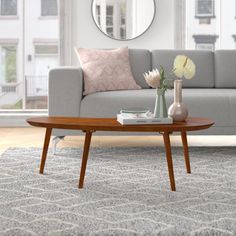 a living room scene with focus on the couch and coffee table in the foreground