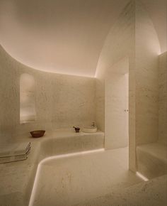 a large white bathroom with two sinks and a bathtub in the middle of it