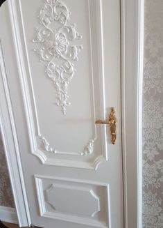 a white door with ornate designs on it