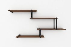 three wooden shelves with black metal brackets on each shelf and the words package c above them