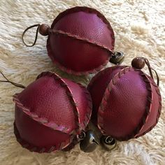 three red leather ornaments on a white carpet