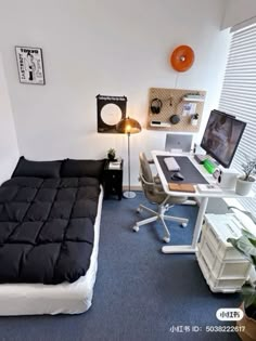 a bedroom with a bed, desk and computer