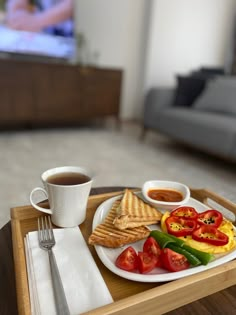 a breakfast tray with toast, vegetables and coffee