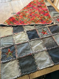 an old patchwork table runner is displayed