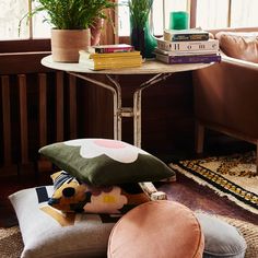 a small table with books and pillows on it