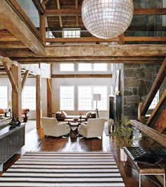 a living room filled with lots of furniture and a chandelier hanging from the ceiling