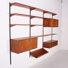 a wall mounted shelving unit with shelves and drawers