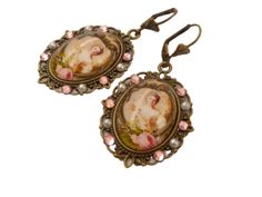 two earrings with pictures on them