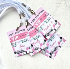 four pink and white tags with barcodes attached to them sitting on a table