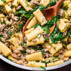 pasta with spinach and sausage in a skillet