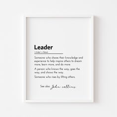 a white framed print with the words leader in black ink on it and a handwritten quote below