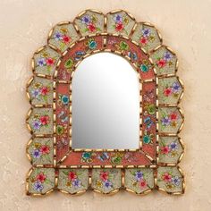 an ornate mirror with colorful flowers on it