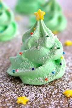 green frosted christmas tree on top of a table with confetti around it