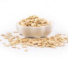 a white bowl filled with oats on top of a table