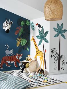 a child's bedroom decorated in blue and white with jungle animals on the wall