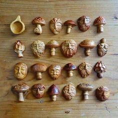 many different types of carved mushrooms on a wooden surface with one missing the top and another missing the bottom