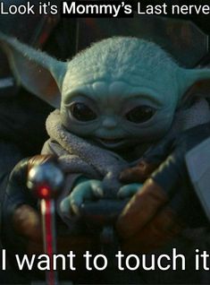 the child yoda from star wars is holding something