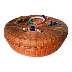 a wicker basket with beads and bracelets on it