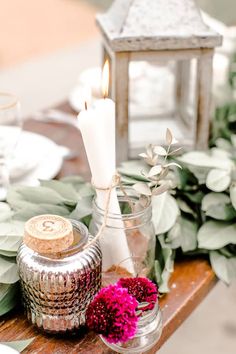 the table is set with candles, flowers and other items on it for an elegant touch