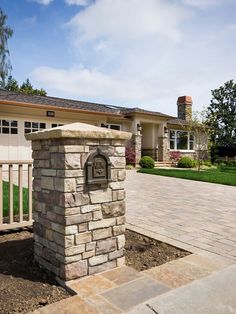 a brick mailbox in front of a house