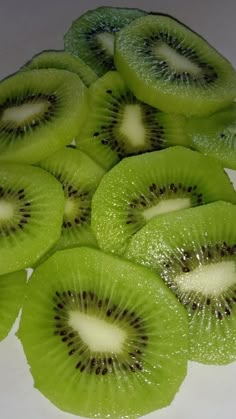 slices of kiwi sitting on top of a white counter