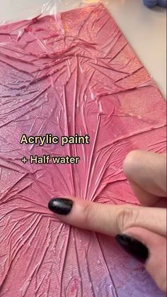 someone using acrylic paint to create a pink flower