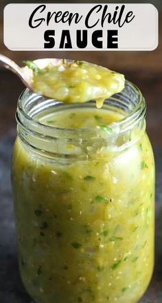 a jar filled with green chile sauce on top of a table