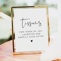 a table with a sign that says tissues for tears of joy, laughter and happily ever after