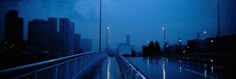 an empty walkway in the middle of a city at night