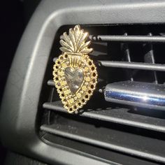 the interior of a car with an ornate gold brooch